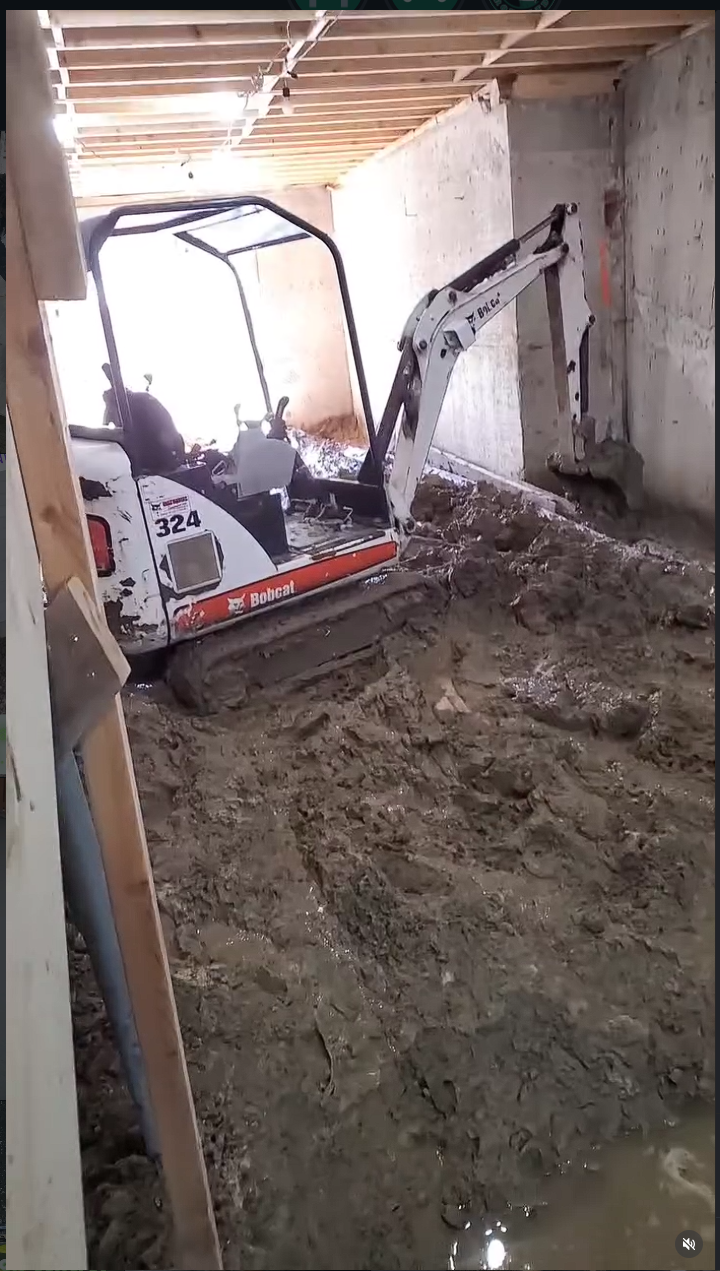 Bobcat 324 excavating inside a basement
