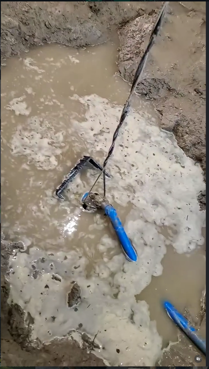 Fresh concrete pour with rebar and blue tools